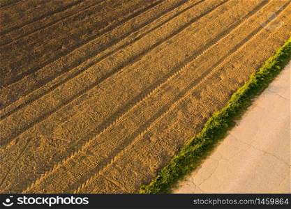 Plowed field in rural area. Landscape of agricultural fields. Aerial view. Plowed field in rural area. Landscape of agricultural fields