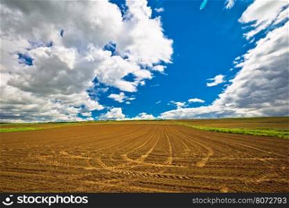 Plowed field under dramatic sky view, agricultural region of Prigorje, Croatia