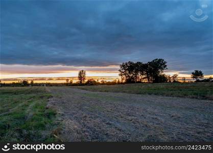 Plowed rural field and evening clouds with sunset, Zarzecze, Lubelskie, Poland