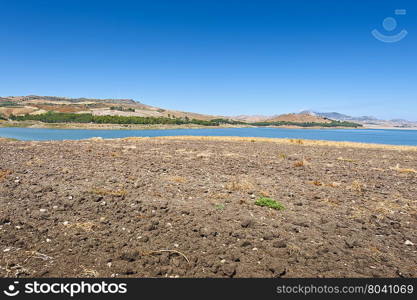 Plowed Shore of the Lake Lago di Ogliastro on the Background of the Mount Etna in Sicily