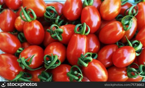 Plum red tomatoes as background