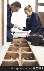 Plumber And Apprentice Fitting Central Heating