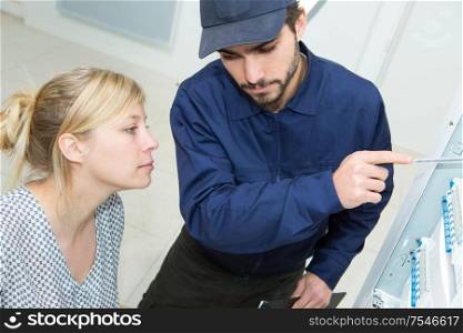 plumber and woman talking at home