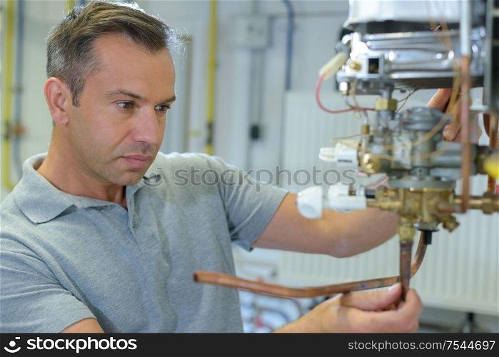 plumber at work on his workbench to fix pipes
