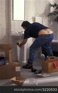 Plumber Bending Over To Fix Sink And Exposing Buttocks