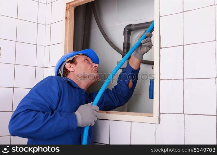plumber connecting a water pipe