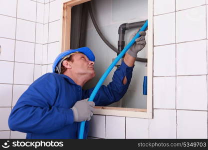 plumber connecting a water pipe