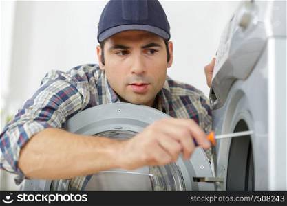 plumber fixing a washing machine
