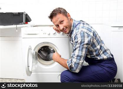 Plumber fixing broken washing machine