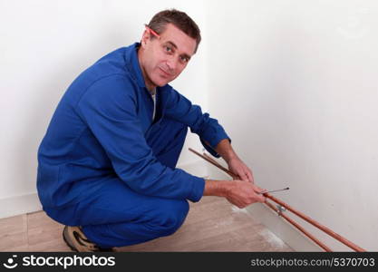 Plumber fixing copper piping