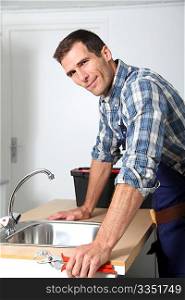 Plumber fixing domestic sink