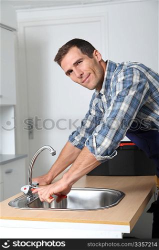 Plumber fixing domestic sink