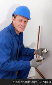 Plumber fixing heating system