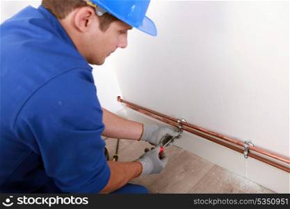Plumber fixing pipes