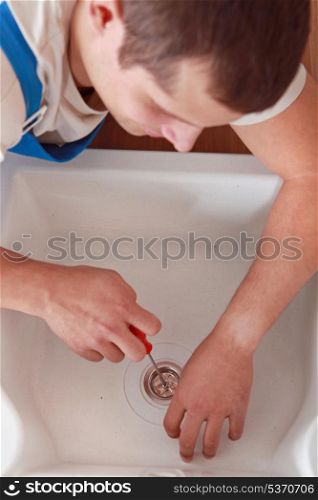 Plumber fixing sink