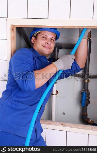 Plumber fixing some pipes