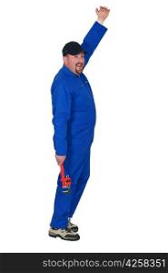 Plumber in boiler suit holding wrench