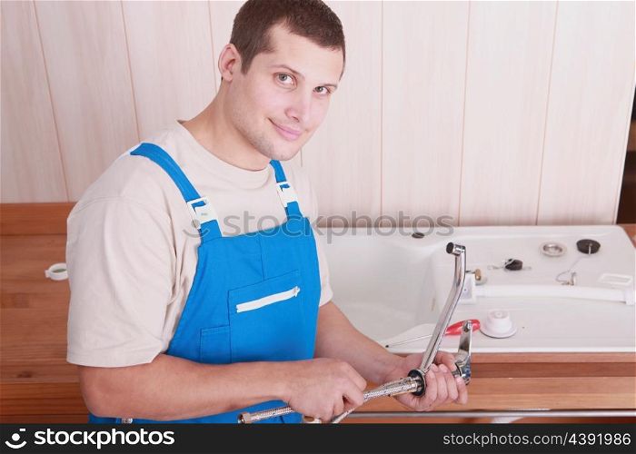 Plumber installing a kitchen sink