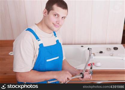 Plumber installing a kitchen sink