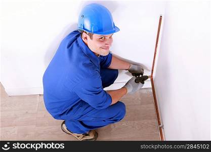 Plumber installing pipes