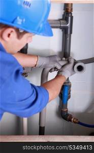 Plumber installing plastic domestic water pipes