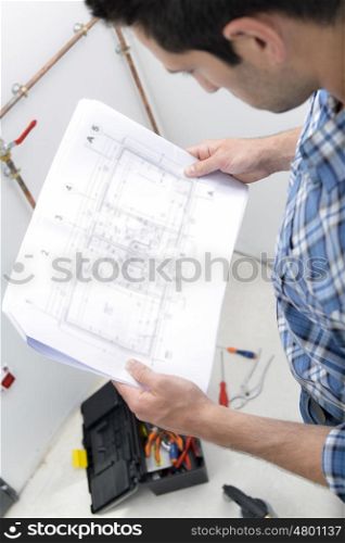 Plumber looking at plans