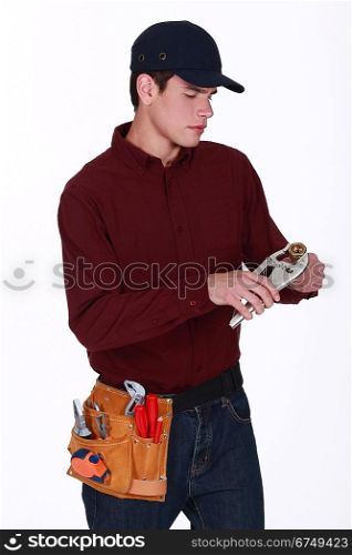 Plumber making adjustments to pipe with wrench