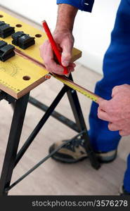 Plumber measuring copper pipe