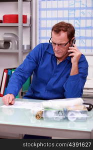 Plumber on the phone in office