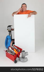 Plumber on the phone with a board left blank for your message