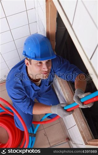 Plumber pulling on pipes
