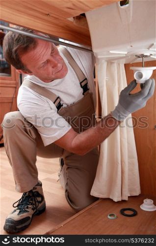 Plumber repairing faucet piping