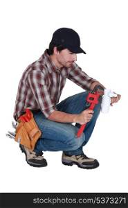 Plumber using a pipe wrench