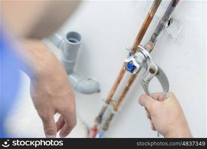 Plumber using a wrench