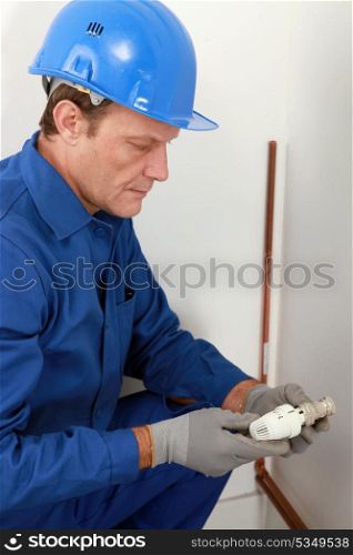 Plumber with a radiator valve
