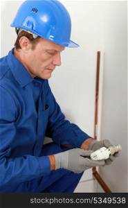 Plumber with a radiator valve