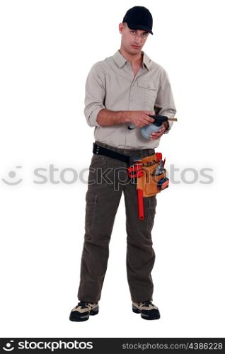 Plumber with blowtorch, studio shot
