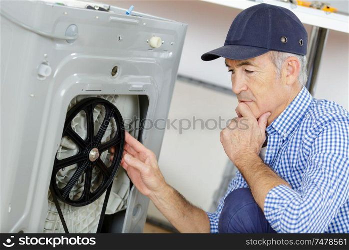plumber with clipboard near washing machine