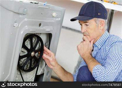 plumber with clipboard near washing machine