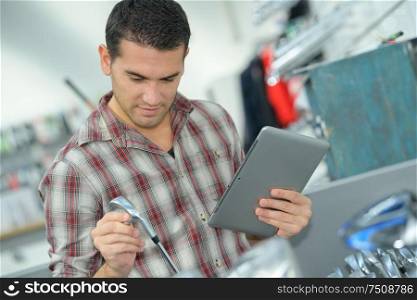 plumber with tablet buying supplies