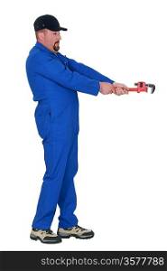 Plumber with wrench pretending to loosen bolt