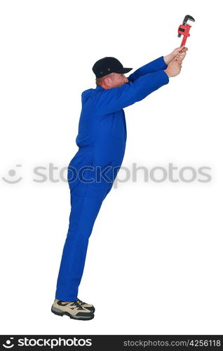 Plumber with wrench reaching upwards