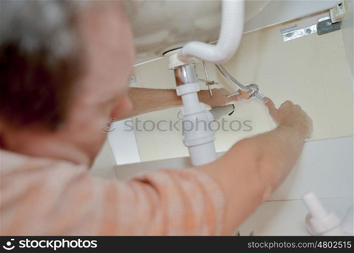 Plumber working in a bathroom