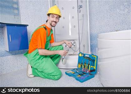 Plumber working in the bathroom