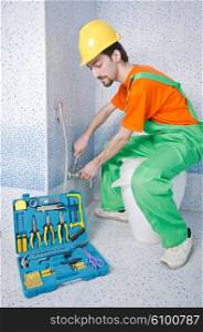 Plumber working in the bathroom