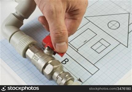 plumbing fittings in hand on the drawing