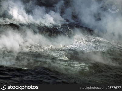 Plumes of stream rising from molten lava, Hawaii