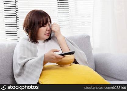 Plump Asian Woman Watching Sad Movie on the Couch