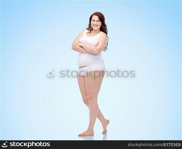 plus size and people concept - happy plus size woman in underwear over blue background. happy plus size woman in underwear