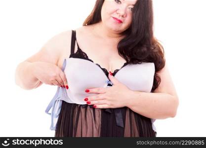 Plus size big adult woman wearing black lace lingerie holding full cup bra, on white. Bosom, brafitting and underwear.. Woman plus size holding bra